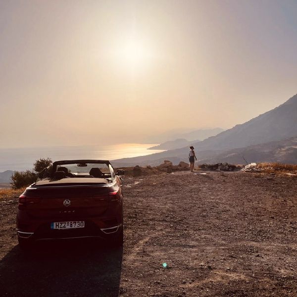 Happy people enjoing a sunny day with a convertible car rental