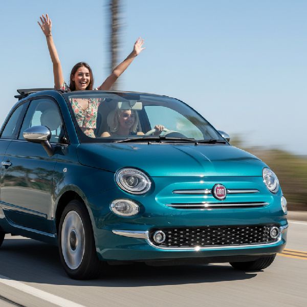 Two young women are enjoying a sunny coastal drive in Crete thanks to their decision to rent a car at Heraklion Airport.